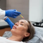 Patient receiving an injection-based treatment in a clinical setting