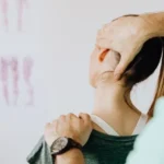 A healthcare professional performing a neck stretching exercise to help relieve neck pain.
