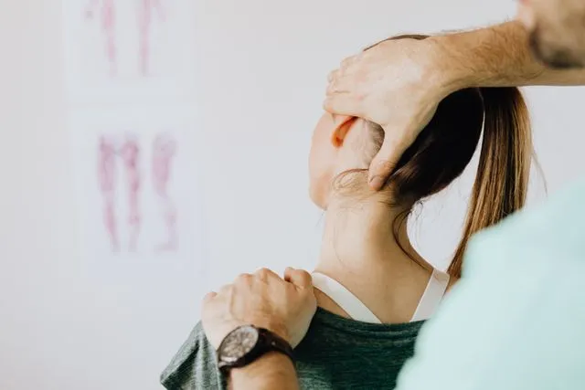 A healthcare professional performing a neck stretching exercise to help relieve neck pain.
